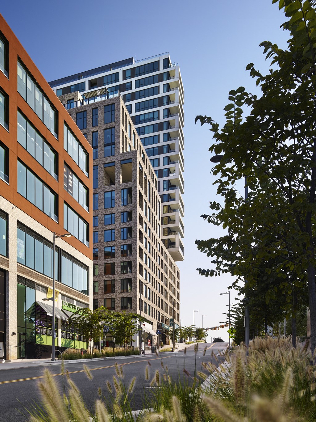 a cityscape with tall buildings and a street in the foreground at The Boro, Tysons Virginia