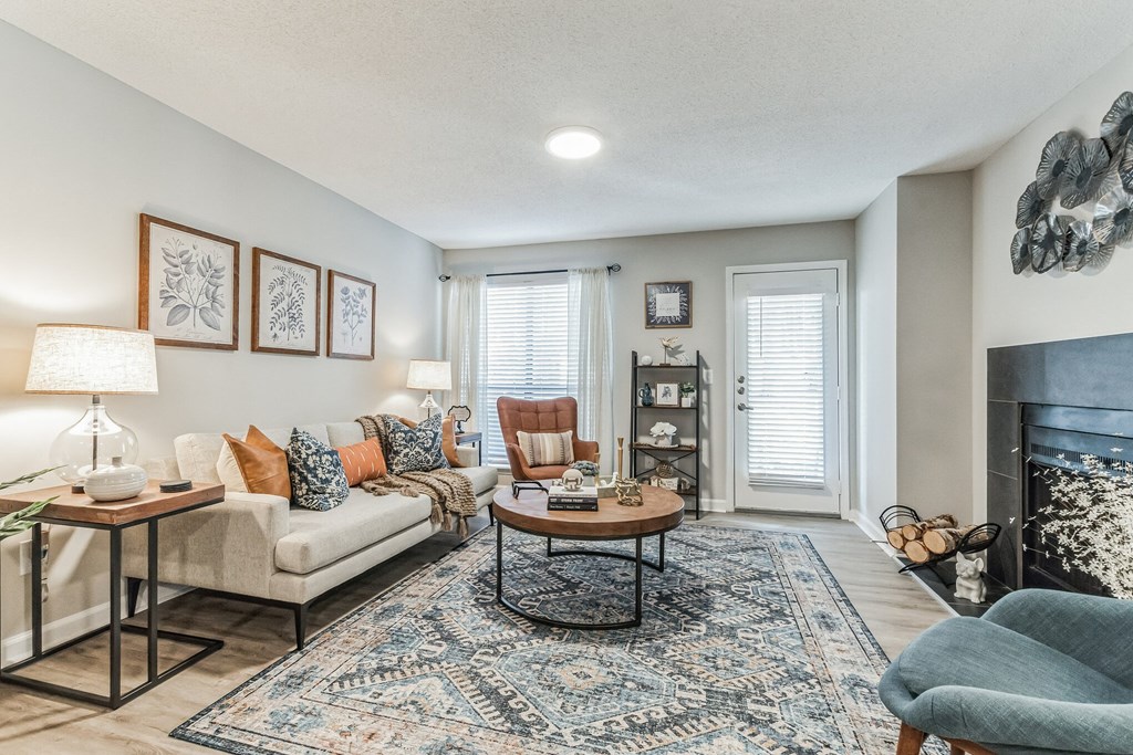 a living room with a fireplace and a couch at Brampton Moors, Cary, 27513