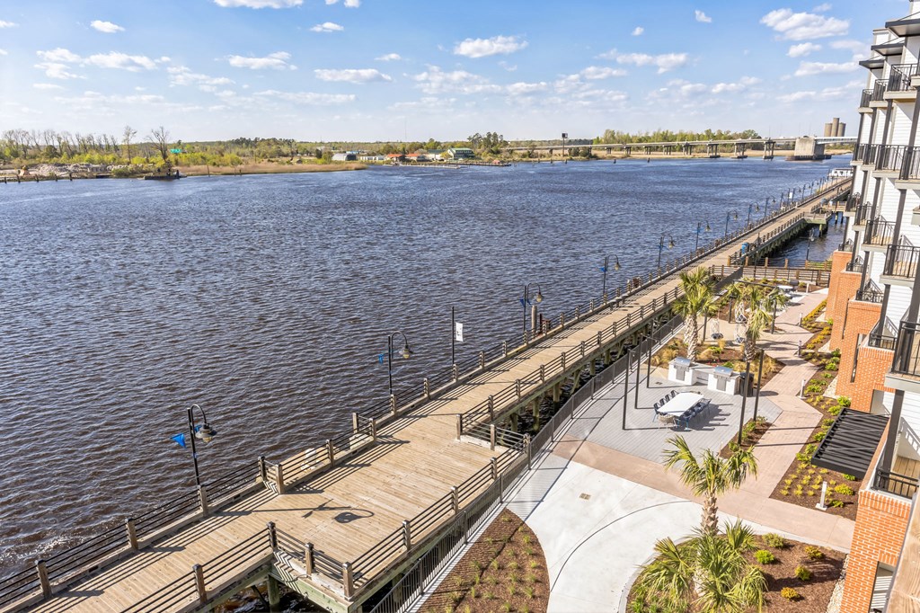 a view of a river from a building with a dock at Metropolitan at the Riverwalk, Wilmington, NC