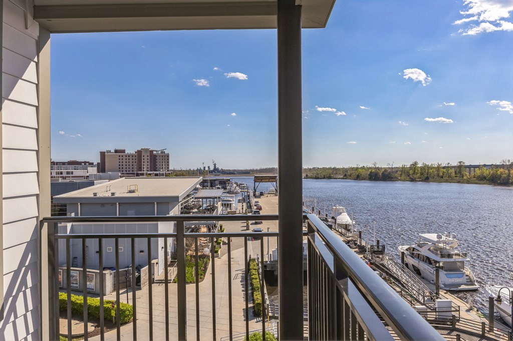 the view of a marina from a balcony with a view of the water at Metropolitan at the Riverwalk, Wilmington, NC