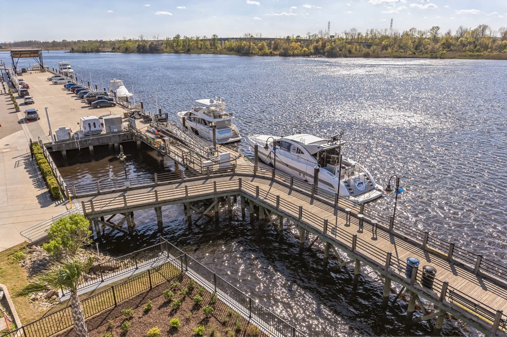 several boats docked at a dock on a body of water at Metropolitan at the Riverwalk, Wilmington, NC