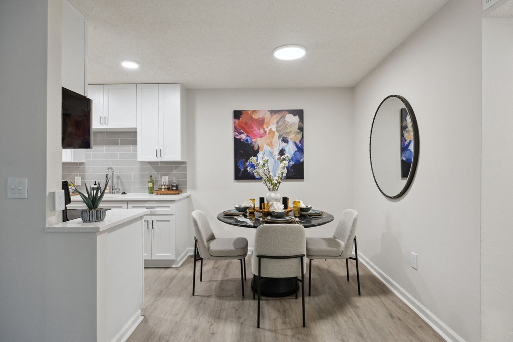 a dining room and kitchen with a table and chairs