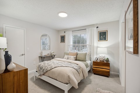 a bedroom with a bed and a window at St. Andrews Reserve, North Carolina