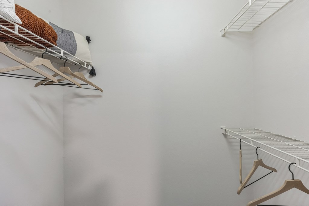 a room with white walls and a closet with shelves and hangers on the wall at St. Andrews Reserve, North Carolina, 28412