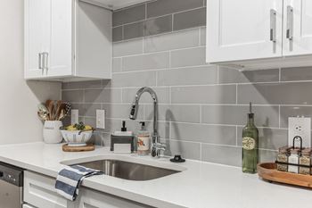 a kitchen with white counter tops and a sink at St. Andrews Reserve, North Carolina, 28412