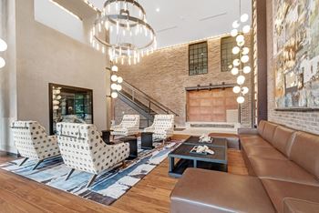 a living room with couches and chairs and a chandelier