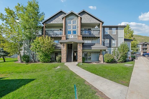 A large two-story house with a balcony on the second floor.