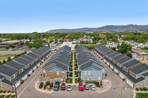 A parking lot with cars and a building in the background.