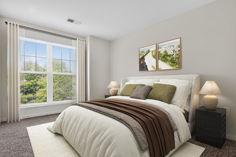 A bedroom with a large bed and a window with curtains.