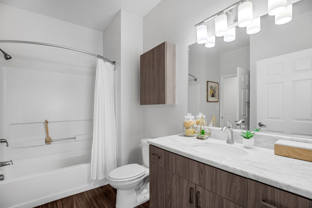 A white bathroom with a toilet, sink, and showerat Lincoln Old Town, Alexandria, VA 22314