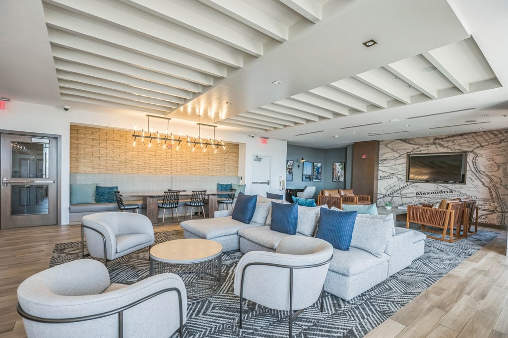 A spacious living room with a stone fireplace and a variety of seating optionsat Lincoln Old Town, Alexandria, VA 22314