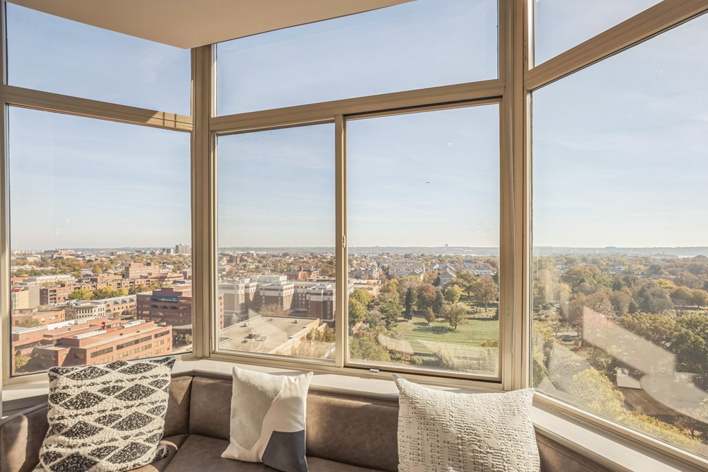 A couch with a pillow sits in front of a large window with a view of a cityat Lincoln Old Town, Alexandria, VA 22314