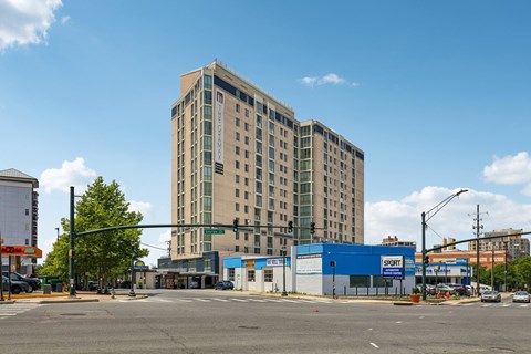 A large building with a blue Sport store in front.