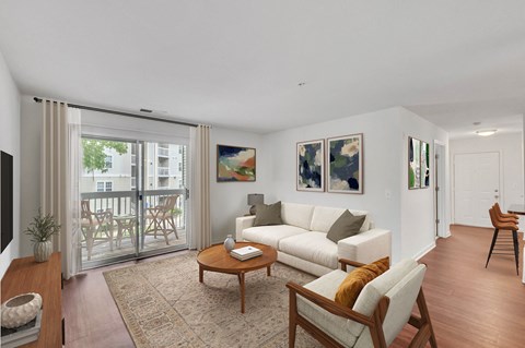 A living room with a white couch, a coffee table, and a painting on the wall.
