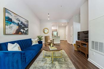 a living room with a blue couch and a coffee table at Lincoln Old Town, Virginia, 22314