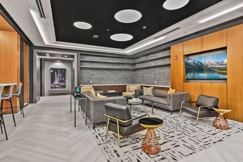 A modern living room with a grey sofa set and a yellow chair.