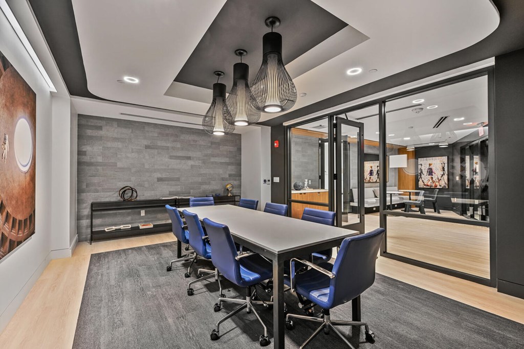 A conference room with a long table and chairs.