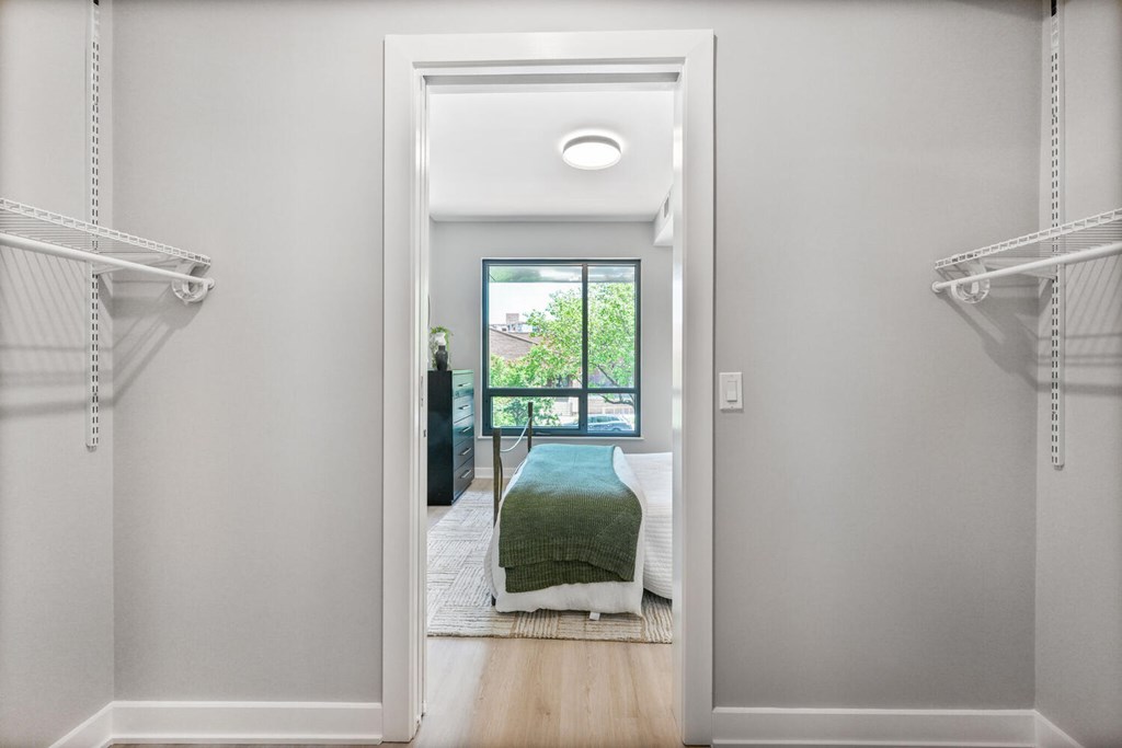 A white room with a bed and a window.