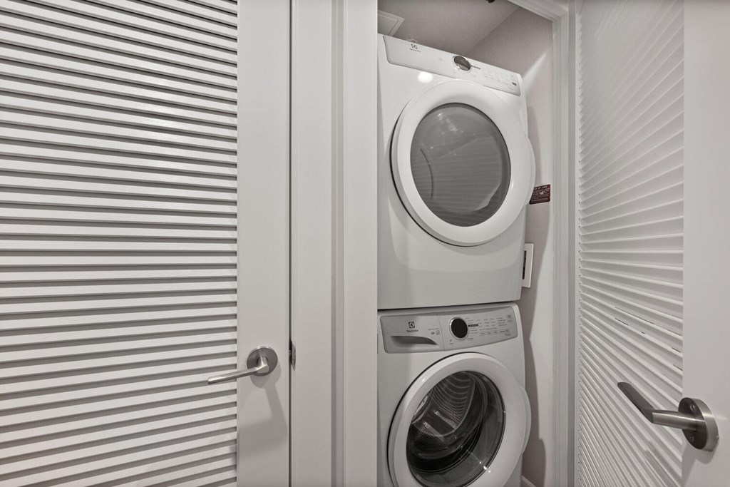 A white washing machine in a small laundry room.