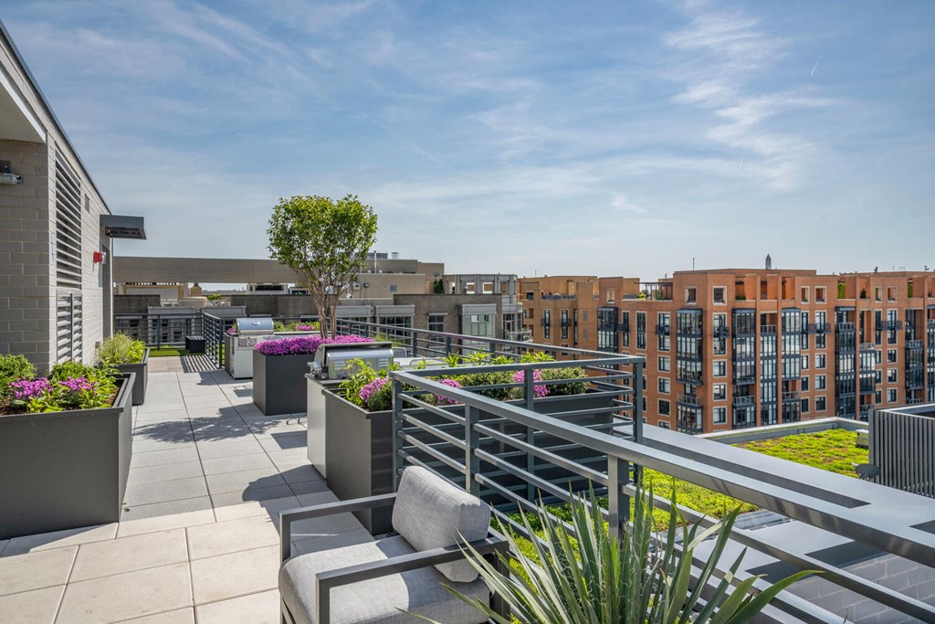 A patio with a table and chairs overlooks a building.