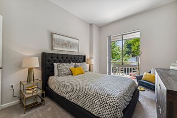 a bedroom with a bed and a large window at Lincoln Old Town, Alexandria Virginia