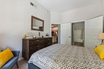 a bedroom with a bed and a dresser and a bathroom at Lincoln Old Town, Virginia