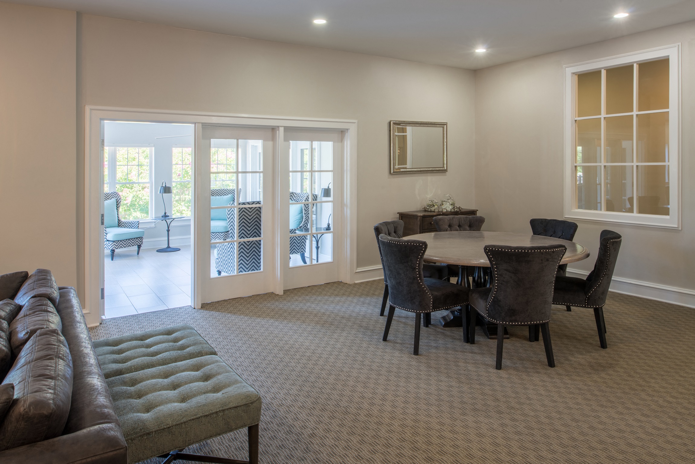 View of clubhouse dining area with French doors leading to bright, airy sun-room at Amberleigh apartments in Fairfax, Virginia 22031