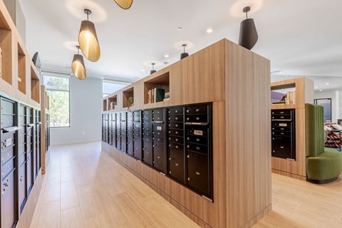 A modern kitchen with wooden cabinets and black appliances.