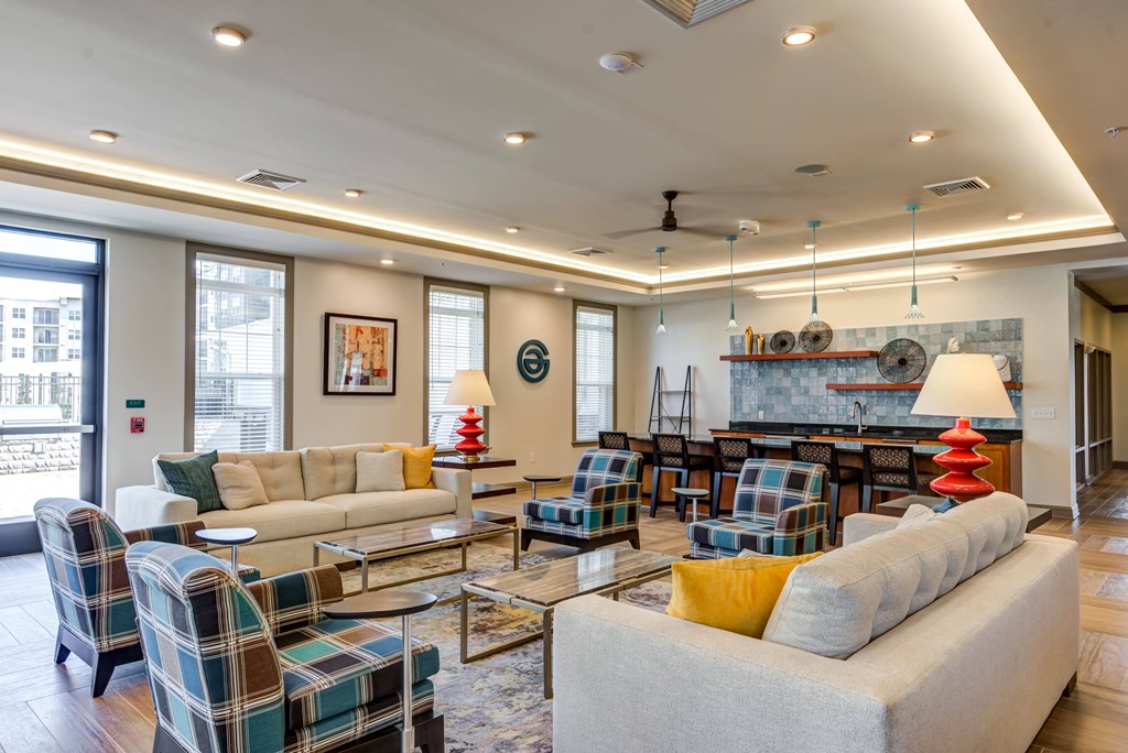 a living room with couches and chairs and a fireplace