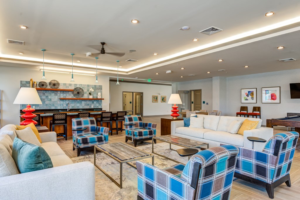 a living room with couches and chairs and a fireplace