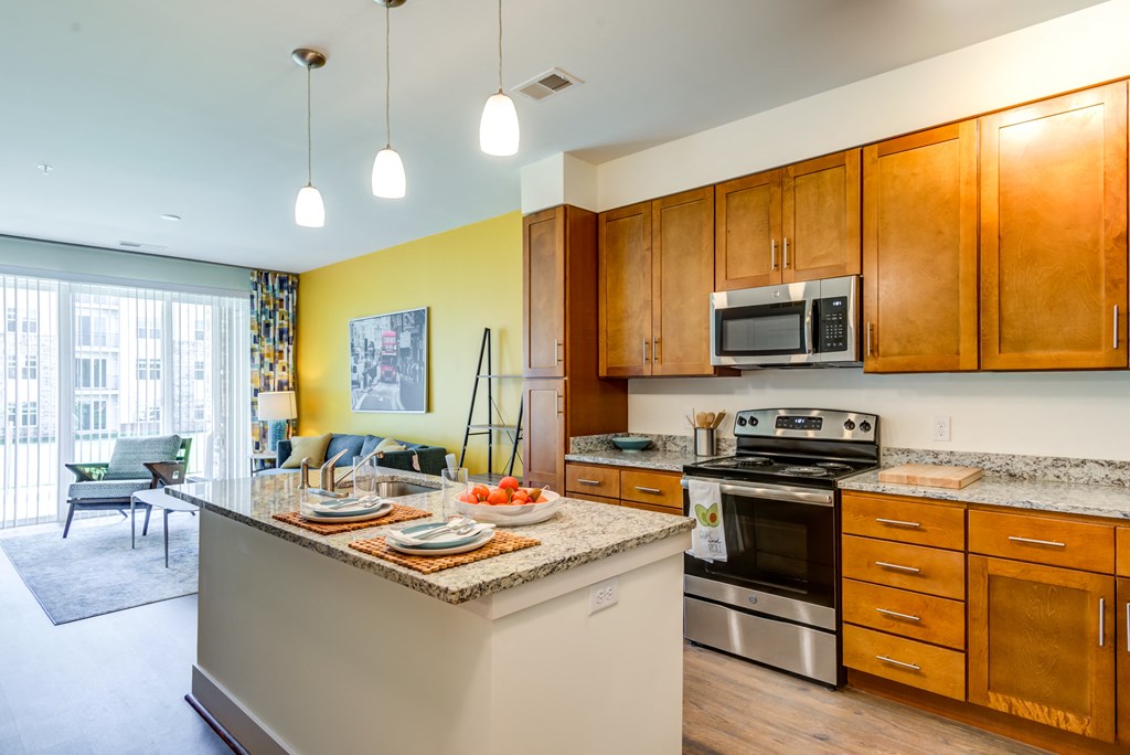a kitchen with an island and stainless steel appliances and wooden cabinets