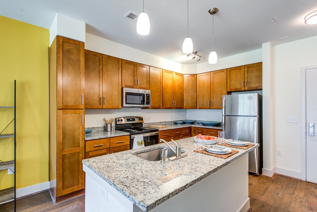 a kitchen with wooden cabinets and granite counter tops
