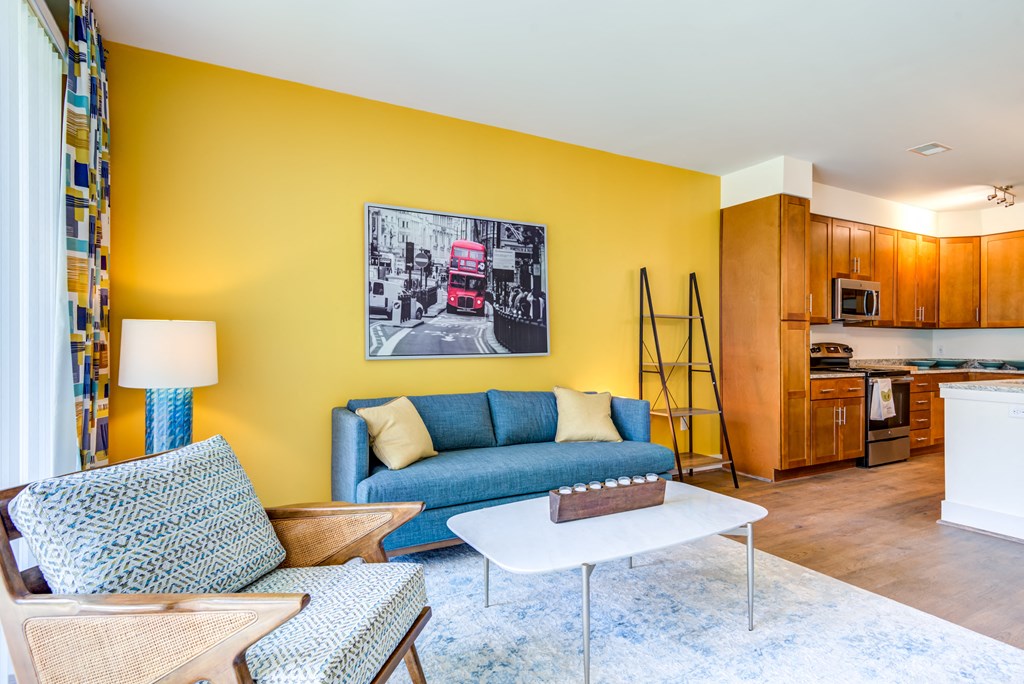 a living room with a blue couch and a table
