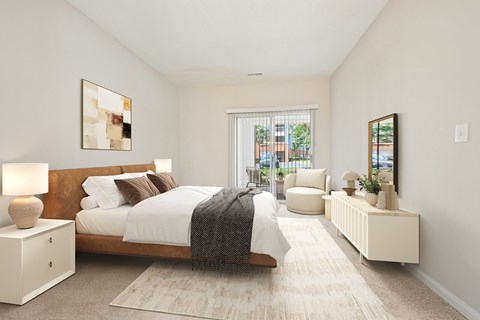 A bedroom with a large bed and a window.