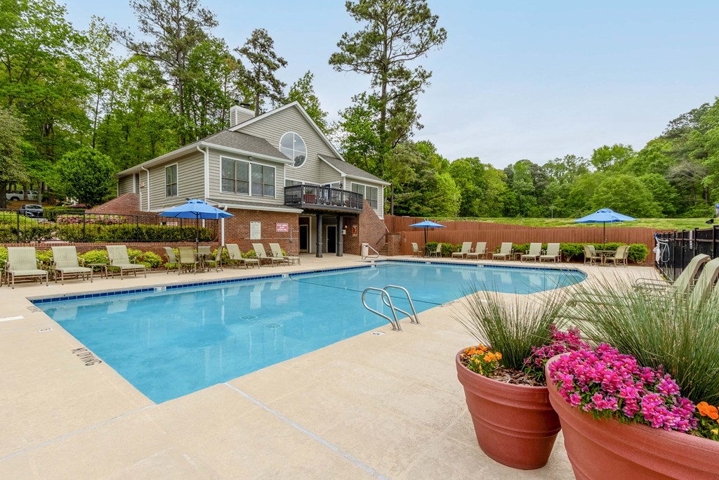 a swimming pool with a house in the background