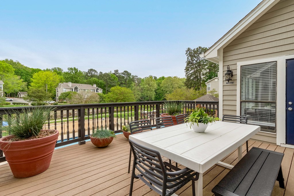 a deck with a table and chairs on it