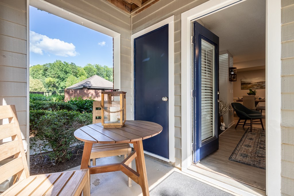 a small table with a lantern on it sits on the porch of a house  at Brampton Moors, North Carolina, 27513
