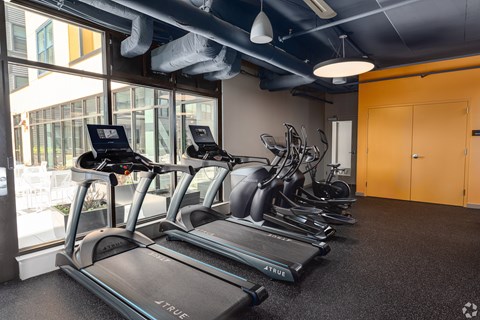 A gym with treadmills and exercise bikes.