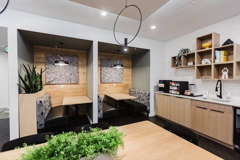 A modern office space with wooden furniture and plants.