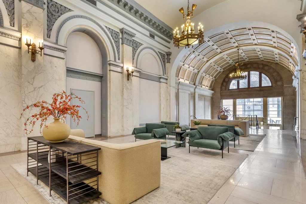 a rendering of the lobby of a building with high ceilings and a large window at The Harriet at the Equitable Building, Baltimore, 21202