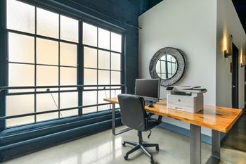 a home office with a computer and a printer on a desk  at The Harriet Apartments, Maryland