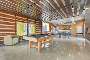 a game room with a pool table in the middle of it at The Harriet Apartments, Maryland