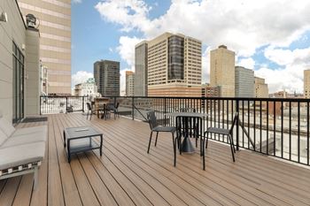 a balcony with a view of the city and a table and chairs at The Harriet at the Equitable Building, Baltimore, MD