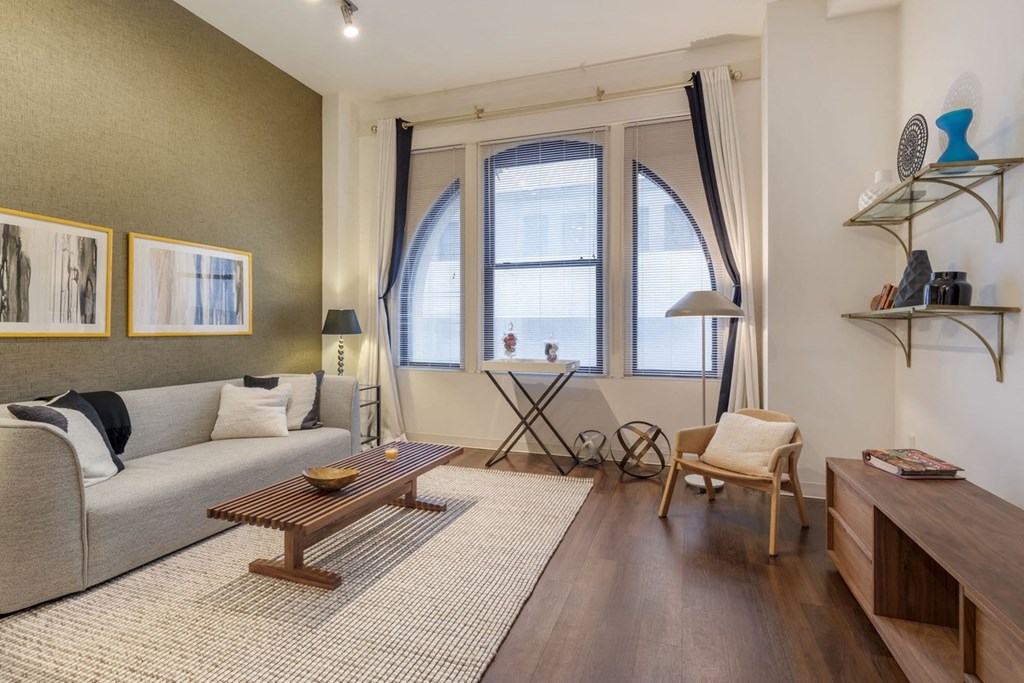 a living room with a couch and a tableat The Harriet at the Equitable Building, Baltimore, 21202