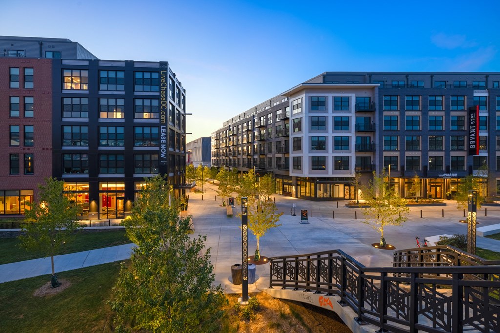 a city street with buildings and trees at night at The Chase at Bryant Street, Washington, DC 20002