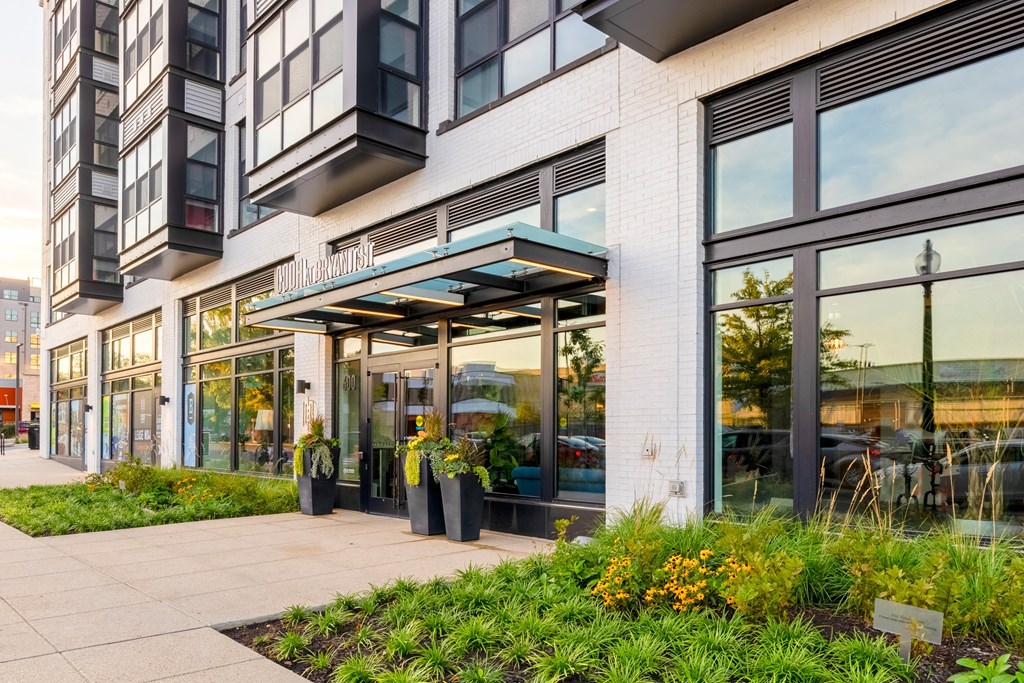 front of a building with large glass windows and a sidewalk at The Chase at Bryant Street, Washington, DC 