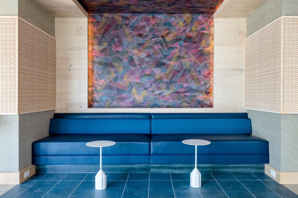 a lobby with blue couches and a painting on the wall at The Chase at Bryant Street, Washington, DC