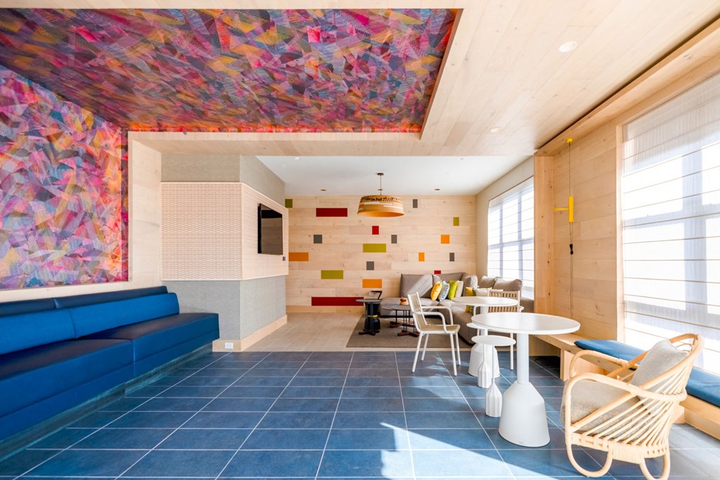 a living room with a blue couch and a table with chairs at The Chase at Bryant Street, Washington, DC 20002