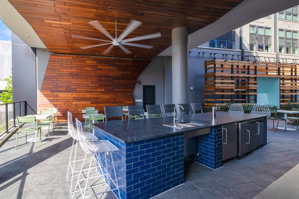 a patio with a bar and chairs and a building in the background a patio with a bar and chairs and a building in the background at The Chase at Bryant Street, Washington
