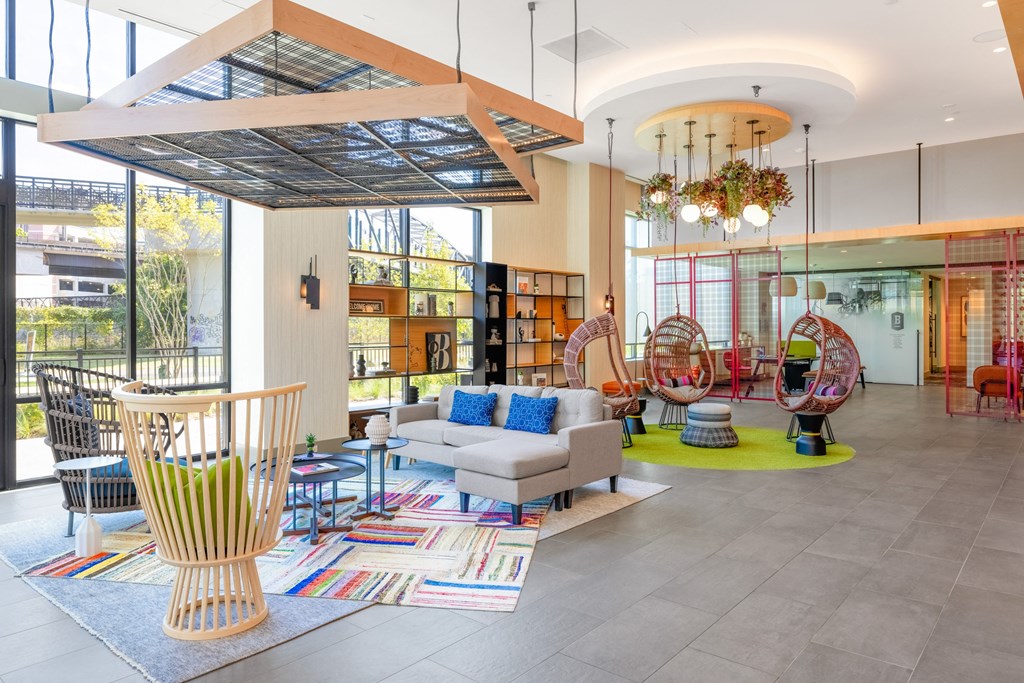 the lobby of a library with chairs and couches and a table at The Chase at Bryant Street, Washington, DC 20002